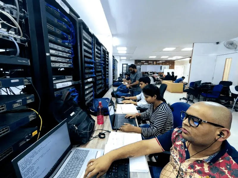 Multi-rack Cisco lab at Networkers Home Bangalore HSR Layout campus with students at workstations